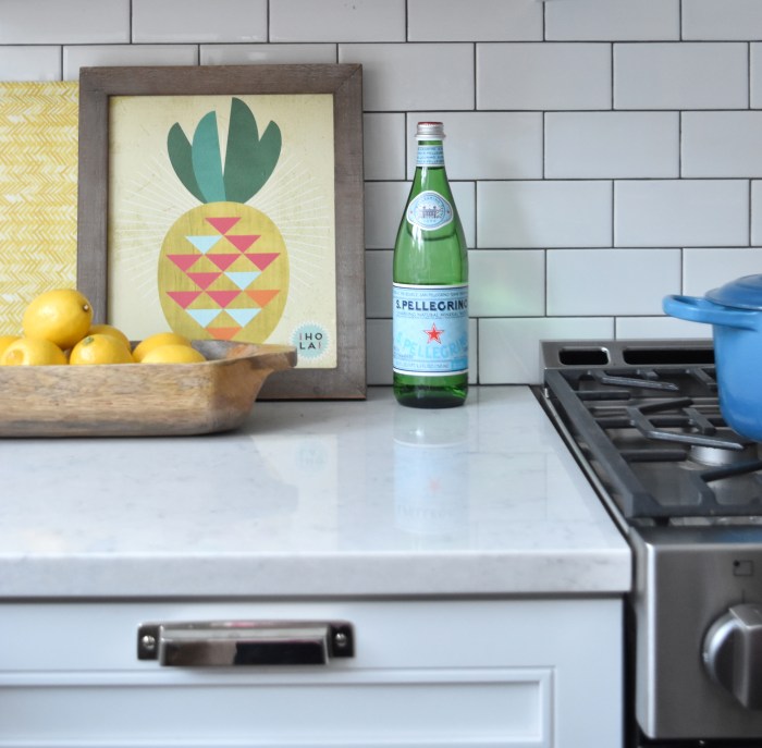 KITCHEN MAKEOVER REVEAL: before and after kitchen renovation with white & gray cabinets, open shelving, subway tile backsplash, quartz countertops, and layers of color. This kitchen is gorgeous! Check out the entire renovation process @ www.JennaBurger.com