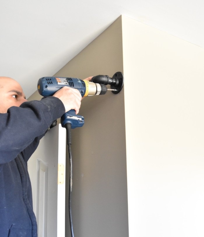 DIY: Rolling door hardware using plumbing pipe. Get the look + function of a rolling door for about $60. Custom size to fit your space. Tutorial by www.JennaBurger.com