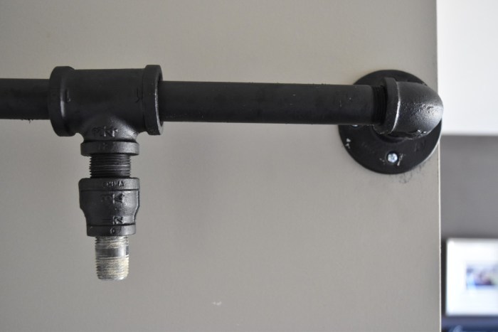 DIY: Rolling door hardware using plumbing pipe. Get the look + function of a rolling door for about $60. Custom size to fit your space. Tutorial by www.JennaBurger.com